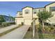 Two-story townhome featuring well-maintained landscaping and private driveways at 4461 Globe Thistle Dr, Tampa, FL 33619