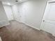 Hallway featuring neutral walls, carpeting, and white doors and trim at 4461 Globe Thistle Dr, Tampa, FL 33619