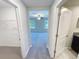 Hallway view into carpeted bedroom with ceiling fan and windows at 4461 Globe Thistle Dr, Tampa, FL 33619