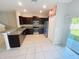 Well-lit kitchen featuring stainless steel appliances, granite countertops and tile floors at 4461 Globe Thistle Dr, Tampa, FL 33619
