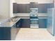 Well-equipped kitchen featuring stainless steel appliances, dark cabinets, and tile flooring at 4461 Globe Thistle Dr, Tampa, FL 33619