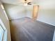 Spacious living room featuring a ceiling fan and neutral carpeting, providing a comfortable and inviting atmosphere at 4461 Globe Thistle Dr, Tampa, FL 33619
