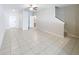 Spacious, open living area with neutral tile flooring and staircase at 4461 Globe Thistle Dr, Tampa, FL 33619