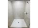 Walk-in shower featuring light tiled walls, a white shower base, and a chrome shower head and faucet at 4461 Globe Thistle Dr, Tampa, FL 33619