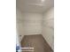 Spacious walk-in closet with carpet flooring, white walls, door and white wire shelving system providing ample storage at 4461 Globe Thistle Dr, Tampa, FL 33619