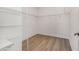 Walk-in closet with wood floor and wire shelving at 4644 Almada Ln, Wesley Chapel, FL 33543