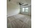 Light-filled carpeted bedroom with ceiling fan and two windows overlooking the yard at 4697 Wandering Way, Wesley Chapel, FL 33544