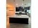 Modern kitchen featuring granite countertops, stainless steel appliances, and a spacious island at 4697 Wandering Way, Wesley Chapel, FL 33544