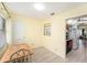 Cozy breakfast nook offers a simple table and chairs, with bright light and access to kitchen at 5216 81St N St # 2, St Petersburg, FL 33709