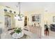Open dining area showcasing table setting and views into the kitchen and bedroom at 5216 81St N St # 2, St Petersburg, FL 33709