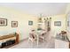 Bright dining area with glass-top table and wicker chairs open to kitchen at 5216 81St N St # 2, St Petersburg, FL 33709