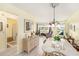 Inviting dining room with glass table and wicker accents, adjoining a bathroom at 5216 81St N St # 2, St Petersburg, FL 33709