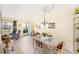Light filled dining area featuring a glass table and chairs open to the living area at 5216 81St N St # 2, St Petersburg, FL 33709