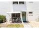 Charming exterior featuring a cozy outdoor seating area, awning, and inviting front door at 5216 81St N St # 2, St Petersburg, FL 33709