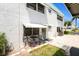 Beautiful exterior with an outdoor seating area, awning, and lush landscaping at 5216 81St N St # 2, St Petersburg, FL 33709