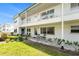 Charming condo featuring a well-manicured lawn, a quaint patio area with seating, and clean white exterior with plenty of natural light at 5216 81St N St # 2, St Petersburg, FL 33709
