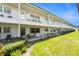 Exterior shot of condo with manicured lawn, garden, and patio seating at 5216 81St N St # 2, St Petersburg, FL 33709