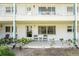 Condo exterior featuring a cozy patio with seating and manicured landscaping at 5216 81St N St # 2, St Petersburg, FL 33709