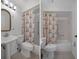 Cozy bathroom featuring a pedestal sink, an ornate mirror, and a tub with shower at 601 N Hercules Ave # 1602, Clearwater, FL 33765