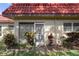 Exterior view of condo with garden and red tile roof at 601 N Hercules Ave # 1602, Clearwater, FL 33765