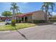 Well-maintained building featuring a red tile roof and neatly manicured landscaping at 601 N Hercules Ave # 1602, Clearwater, FL 33765
