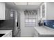 Bright kitchen featuring updated white cabinets, marble countertops, and stainless steel appliances at 601 N Hercules Ave # 1602, Clearwater, FL 33765