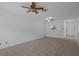 Spacious living room featuring neutral tile flooring, ceiling fan, and direct access to entry door at 601 N Hercules Ave # 1602, Clearwater, FL 33765