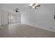 Spacious living room with tiled floors and fan, bathed in natural light from the sliding glass doors at 601 N Hercules Ave # 1602, Clearwater, FL 33765