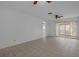 Bright living room with tiled floor, fan, and sliding glass doors to enjoy the outdoors at 601 N Hercules Ave # 1602, Clearwater, FL 33765