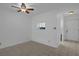Bright living room with neutral tile flooring, ceiling fan and a convenient kitchen pass-through window at 601 N Hercules Ave # 1602, Clearwater, FL 33765