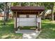 Community mailbox stand with many individual boxes, surrounded by green grass and mature trees at 601 N Hercules Ave # 1602, Clearwater, FL 33765