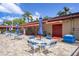 Outdoor seating with umbrellas by the community pool area, perfect for socializing at 601 N Hercules Ave # 1602, Clearwater, FL 33765