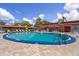 Sparkling community pool surrounded by comfortable lounge chairs and umbrellas, perfect for relaxation at 601 N Hercules Ave # 1602, Clearwater, FL 33765