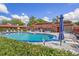 Inviting community pool area, featuring a clear pool, umbrellas, and ample seating for residents at 601 N Hercules Ave # 1602, Clearwater, FL 33765