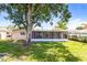 The home features a screened in patio overlooking a beautiful backyard and mature landscaping at 608 Lemonwood Dr, Oldsmar, FL 34677