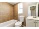 Bathroom features a bathtub with tile surround, toilet, and vanity with mirror at 608 Lemonwood Dr, Oldsmar, FL 34677
