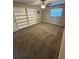 Carpeted bedroom with a window and shelving unit, creating a comfortable retreat at 608 Lemonwood Dr, Oldsmar, FL 34677