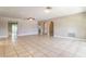 Spacious living room with tile floors, ceiling fan, and arched doorways at 608 Lemonwood Dr, Oldsmar, FL 34677