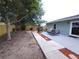 Expansive backyard featuring a patio, fire pit, and mature trees for shade and privacy at 612 Bryan Terrace Dr, Brandon, FL 33511