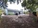 Spacious backyard featuring a stone fire pit and a concrete patio perfect for outdoor gatherings at 612 Bryan Terrace Dr, Brandon, FL 33511