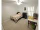Cozy bedroom featuring a ceiling fan, a quaint bed, and a compact workspace at 612 Bryan Terrace Dr, Brandon, FL 33511