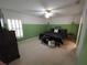 Bright bedroom with large window, featuring neutral carpet, updated ceiling fan, and stylish furnishings at 612 Bryan Terrace Dr, Brandon, FL 33511