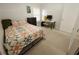 Sunlit bedroom with a colorful quilt, workspace, and a bright window, perfect for relaxation at 612 Bryan Terrace Dr, Brandon, FL 33511
