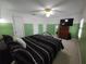 Bright bedroom with ceiling fan, carpet, and ample closet space at 612 Bryan Terrace Dr, Brandon, FL 33511
