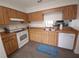 Well-lit kitchen with wood cabinetry, modern appliances, and practical tile flooring at 612 Bryan Terrace Dr, Brandon, FL 33511