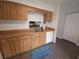Functional kitchen with light wood cabinets, tile flooring, and stainless steel sink at 612 Bryan Terrace Dr, Brandon, FL 33511