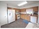Bright kitchen with white appliances, wood cabinets, ample counter space, and tile floors at 612 Bryan Terrace Dr, Brandon, FL 33511