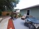 Inviting outdoor patio with comfortable lounge chair and dining set on the home's exterior at 612 Bryan Terrace Dr, Brandon, FL 33511