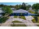 Aesthetic aerial view of a single-story home with well-manicured lawn and a beautiful open backyard at 6511 Georgia Ave, Bradenton, FL 34207