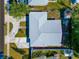 Overhead aerial view of a single-story home's roof, lawn, driveway and surrounding neighborhood at 6511 Georgia Ave, Bradenton, FL 34207